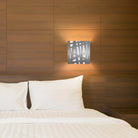 The Zen Wall Sconce sticks style in silver in a bedroom lifestyle photograph.